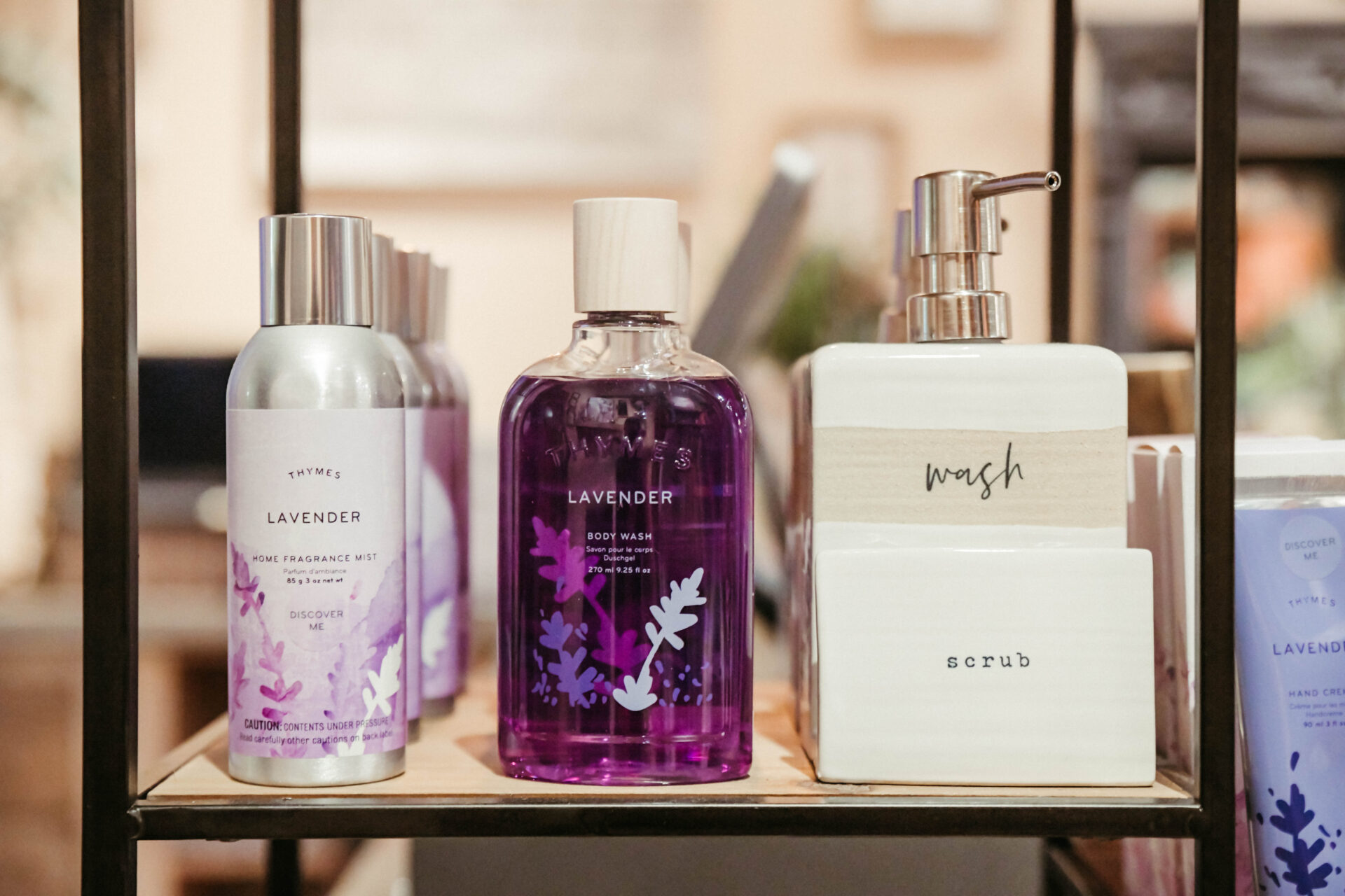 Thymes Fragrance mist, body wash and scrub bottles in the shelf